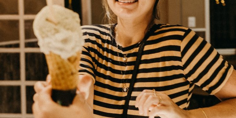 smiling woman reaching for ice cream