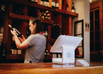 woman standing and looking on bottle